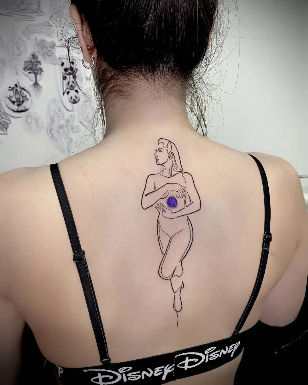 Elegant yoga-inspired tattoo on the back