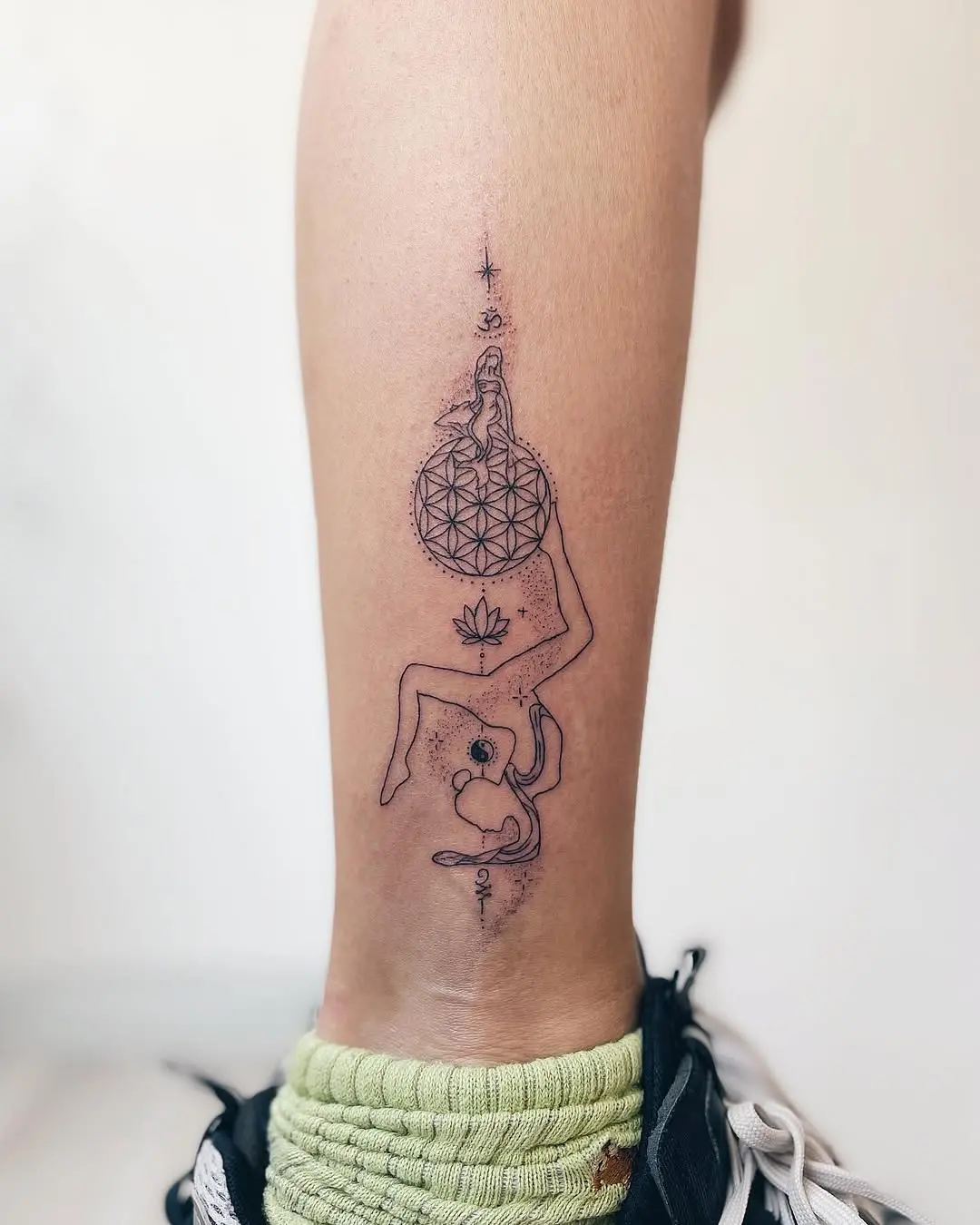 Elegant geometric yoga tattoo with meditative elements