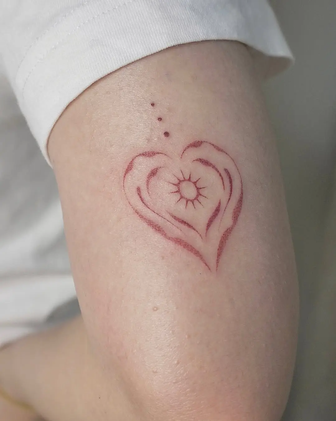 A heart tattoo embodying sun and energy