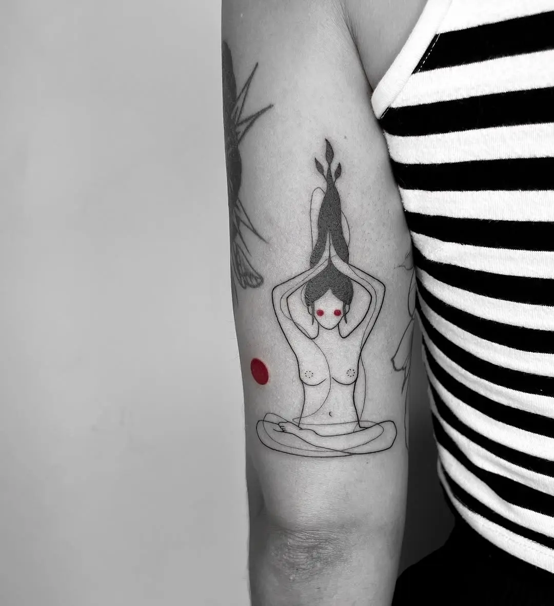 Serene yoga tattoo depicting focused meditation