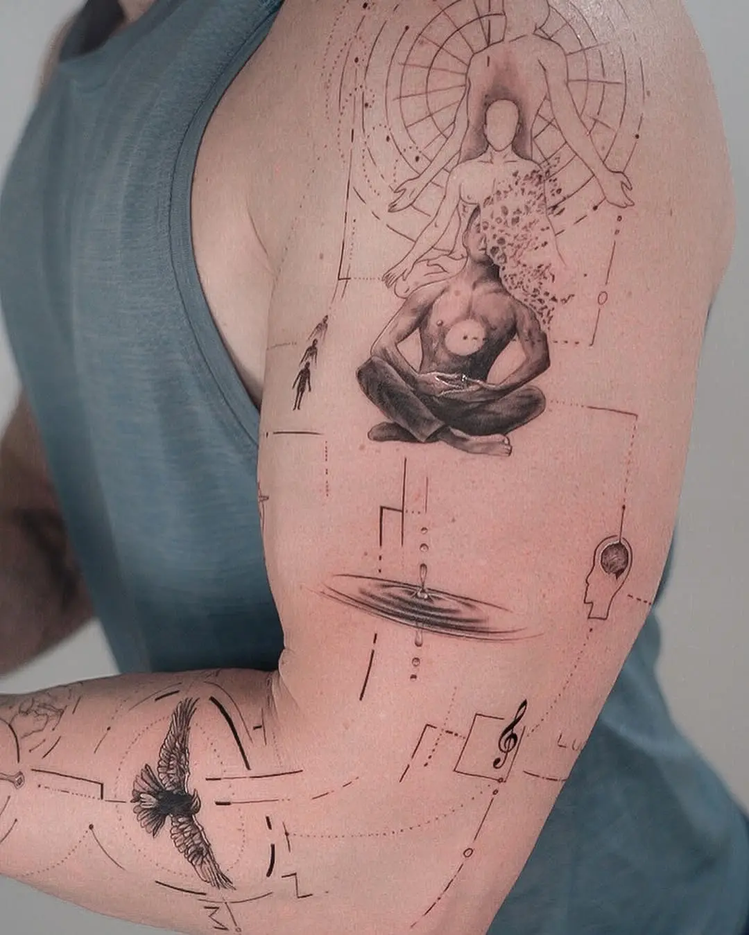 Intricate yoga-themed arm tattoo design.