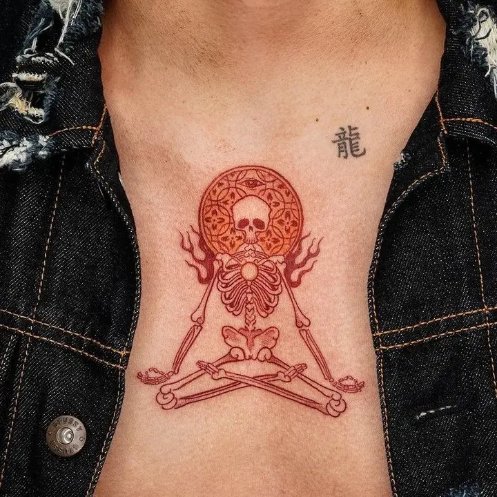 Intricate skull and skeleton yoga design tattoo