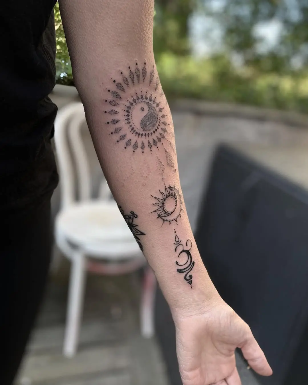 Elegant yoga-inspired tattoo designs on the arm