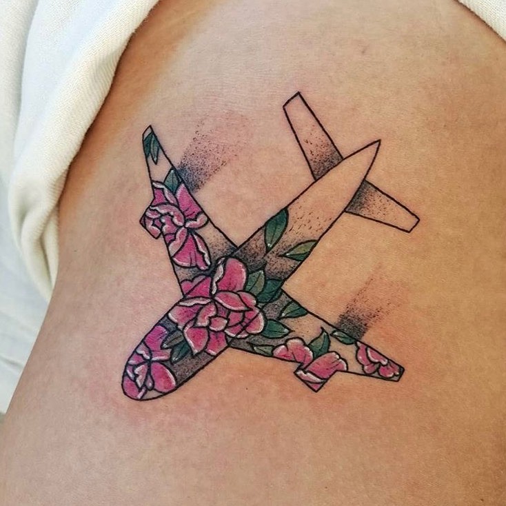 Floral airplane tattoo with vibrant colors.