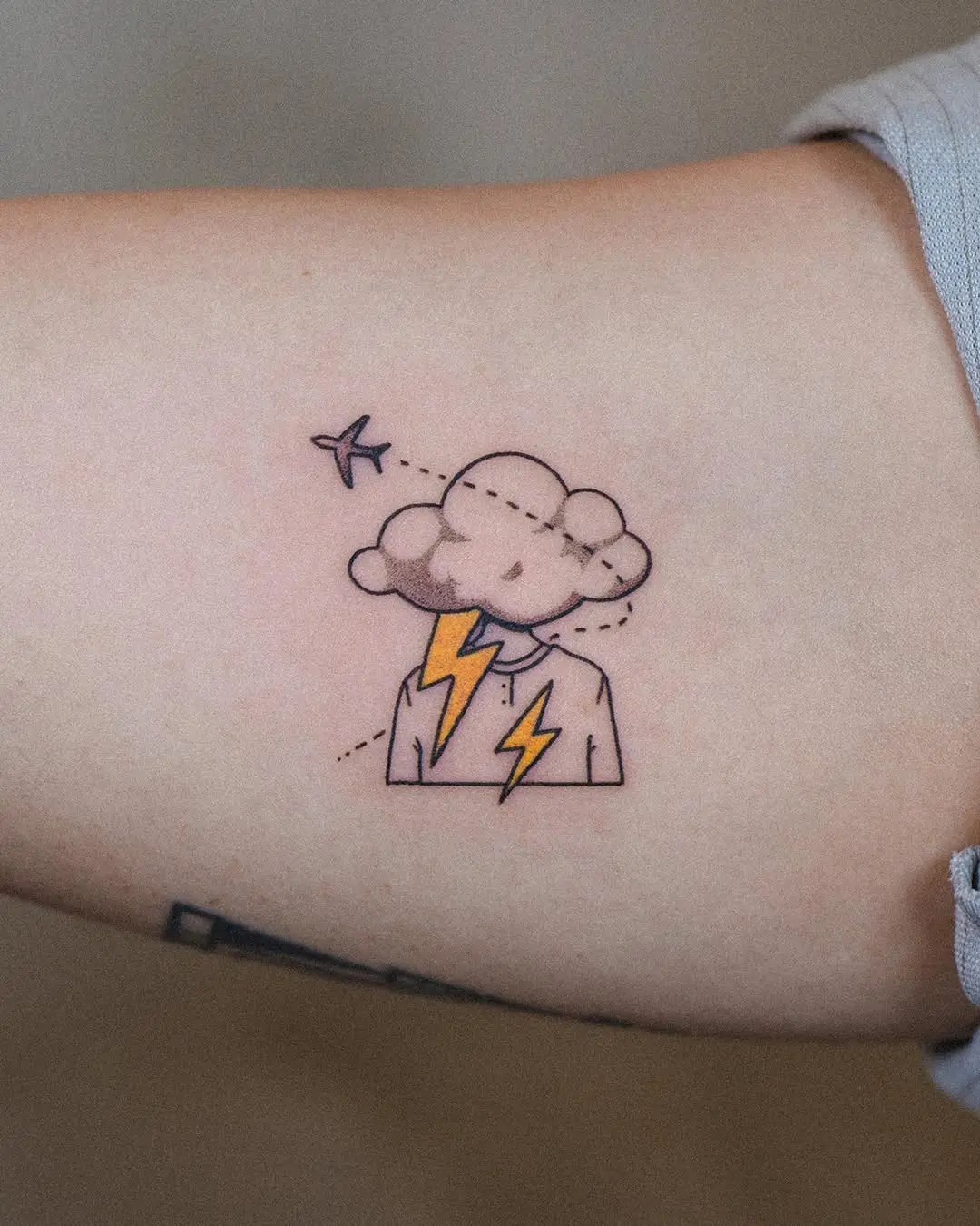 Whimsical airplane tattoo with a thunderstorm theme