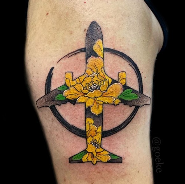Beautiful airplane tattoo with floral elements