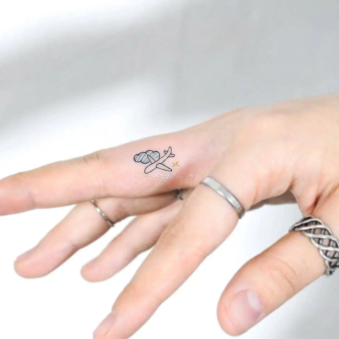 Charming airplane tattoo on the hand
