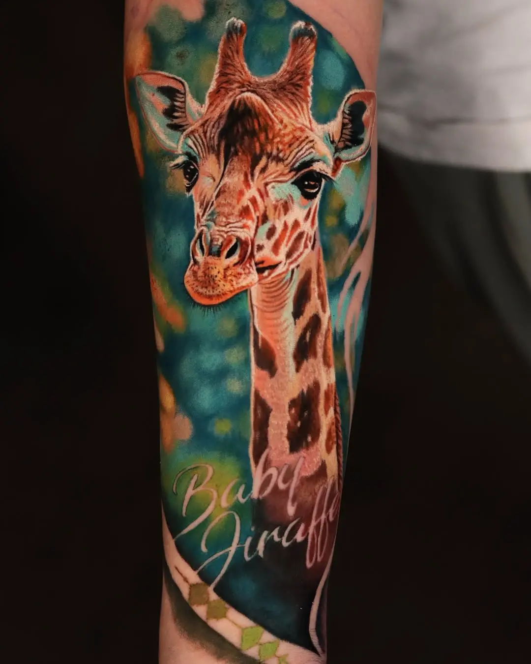 Whimsical baby giraffe tattoo with vibrant colors