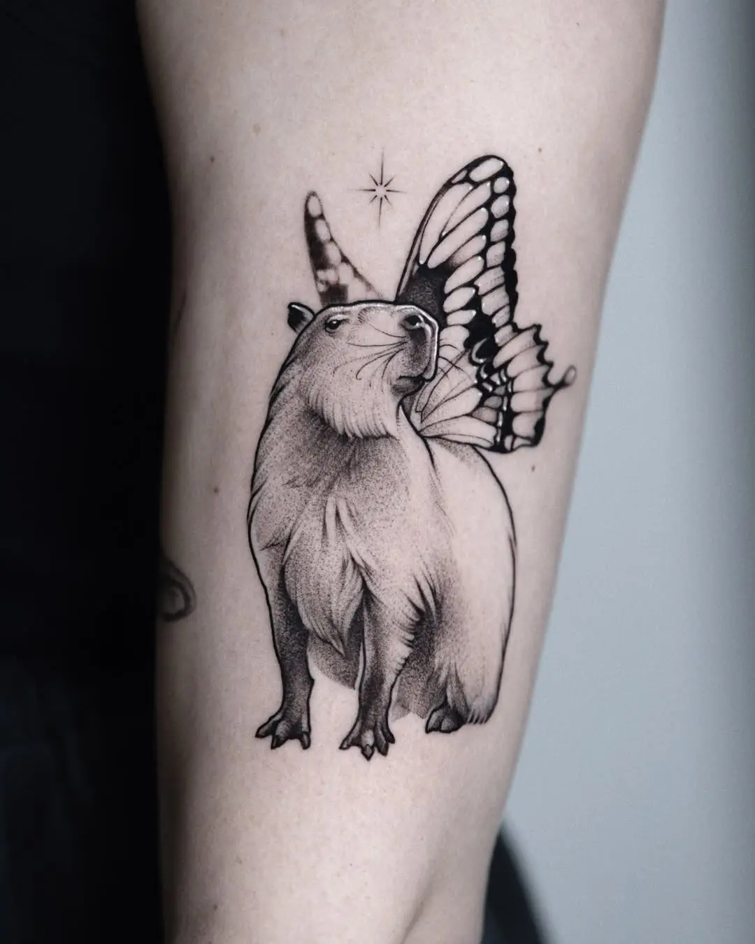 Capybara with whimsical butterfly wings tattoo