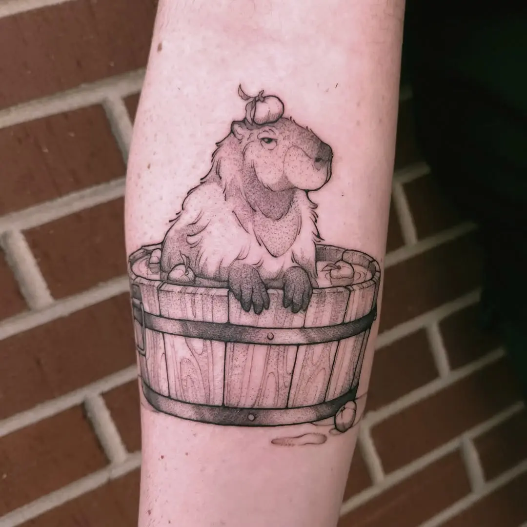 Charming capybara tattoo in a wooden bucket