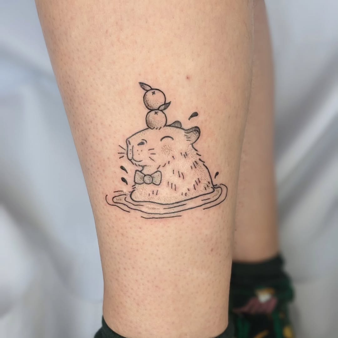 Playful Capybara Tattoo with Adorable Ducks