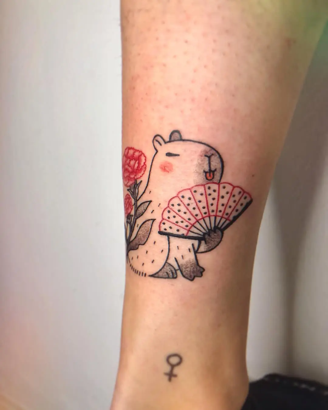 Charming capybara holding a fan and flowers
