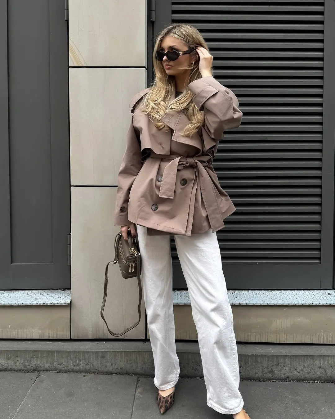 Stylish trench coat paired with white pants