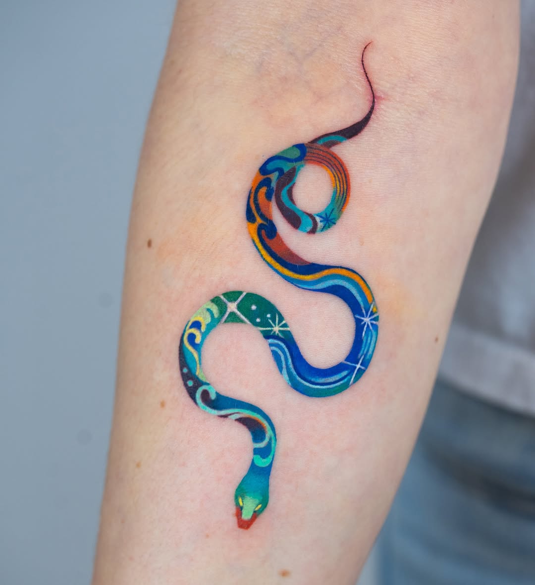 Vibrant snake tattoo with artistic details