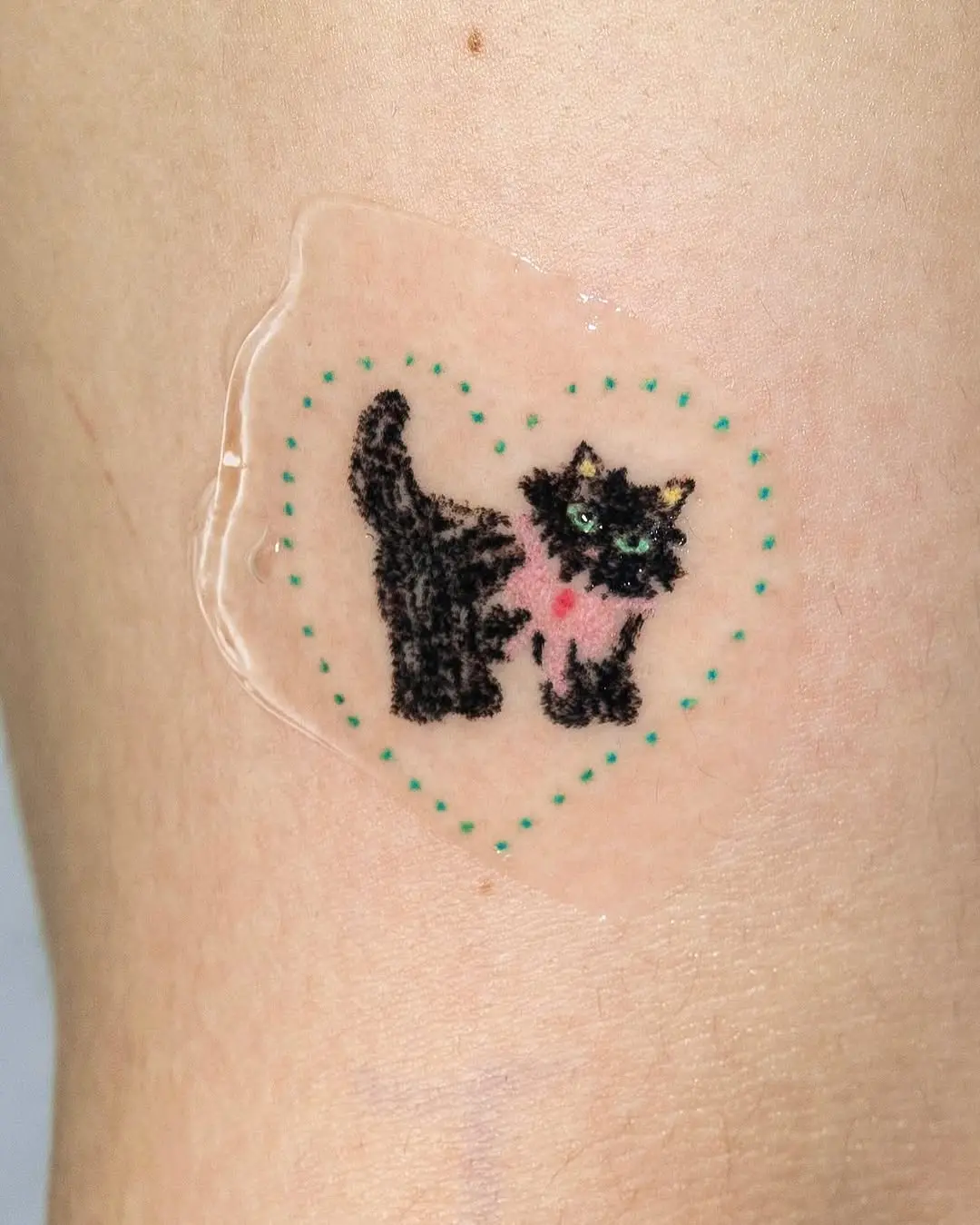 Adorable black cat tattoo with heart design