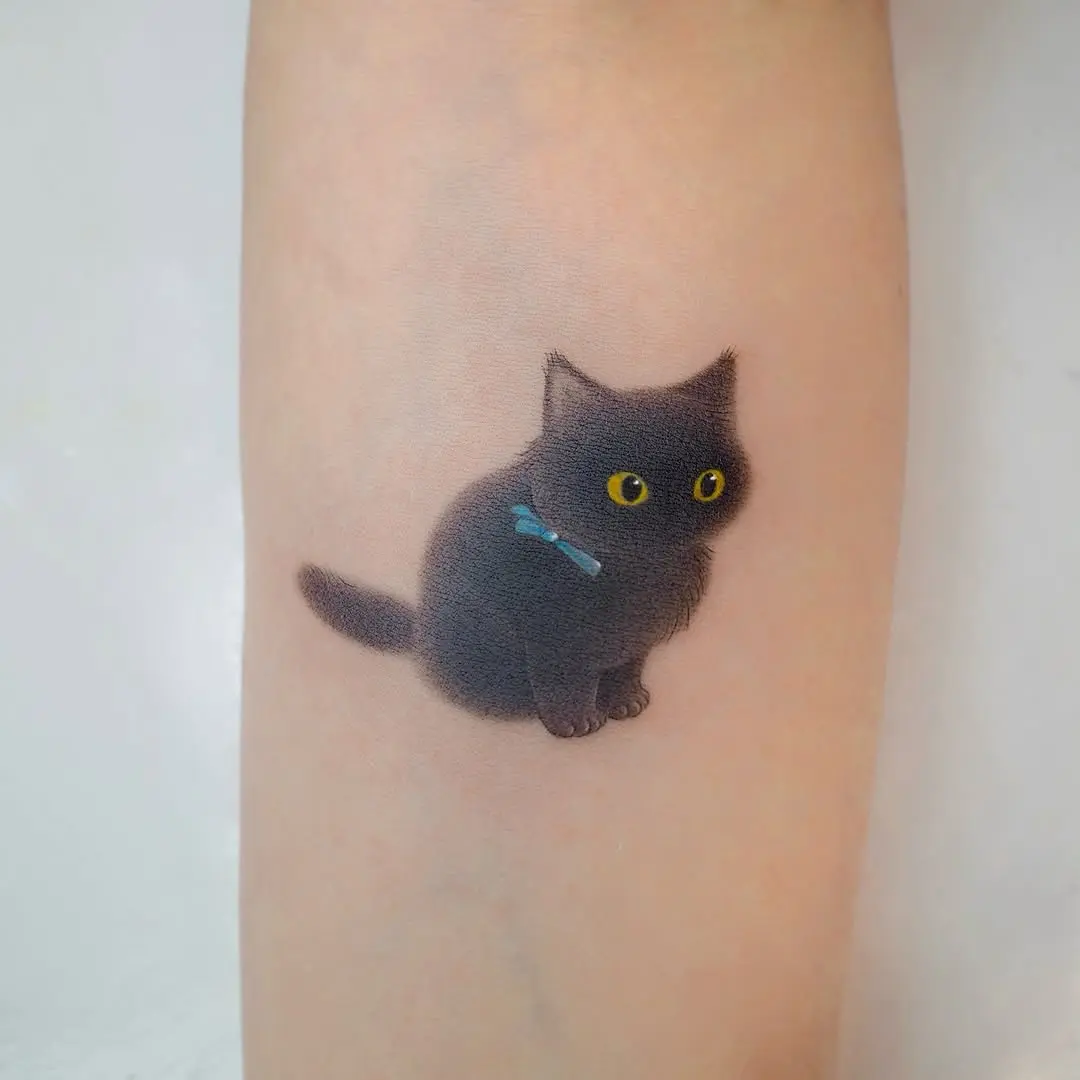 Adorable black cat tattoo with striking yellow eyes