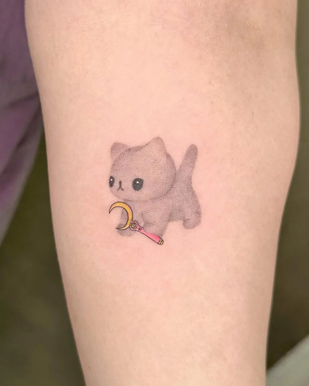 Adorable kitten tattoo with a playful twist