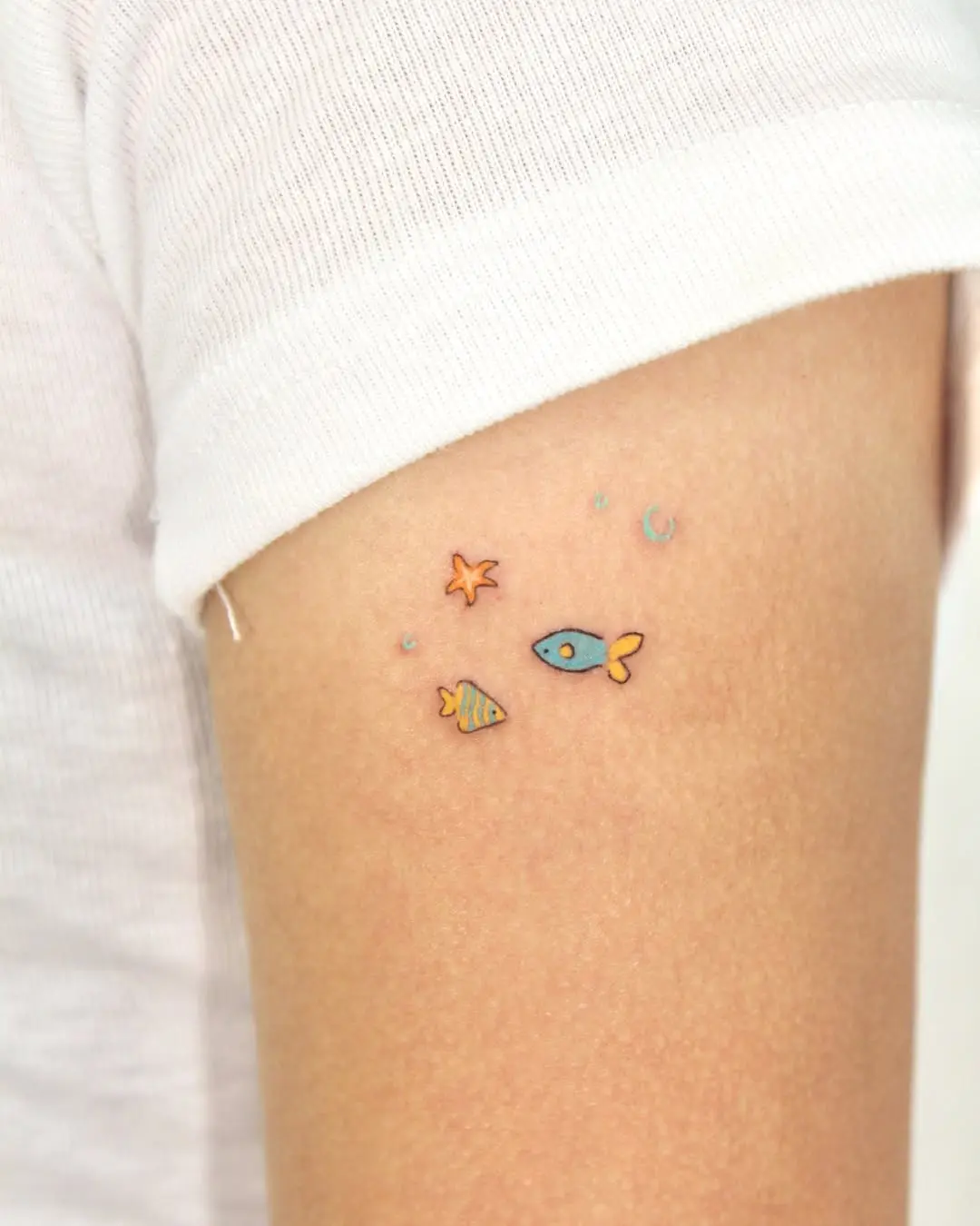 Adorable underwater-themed tattoo on arm