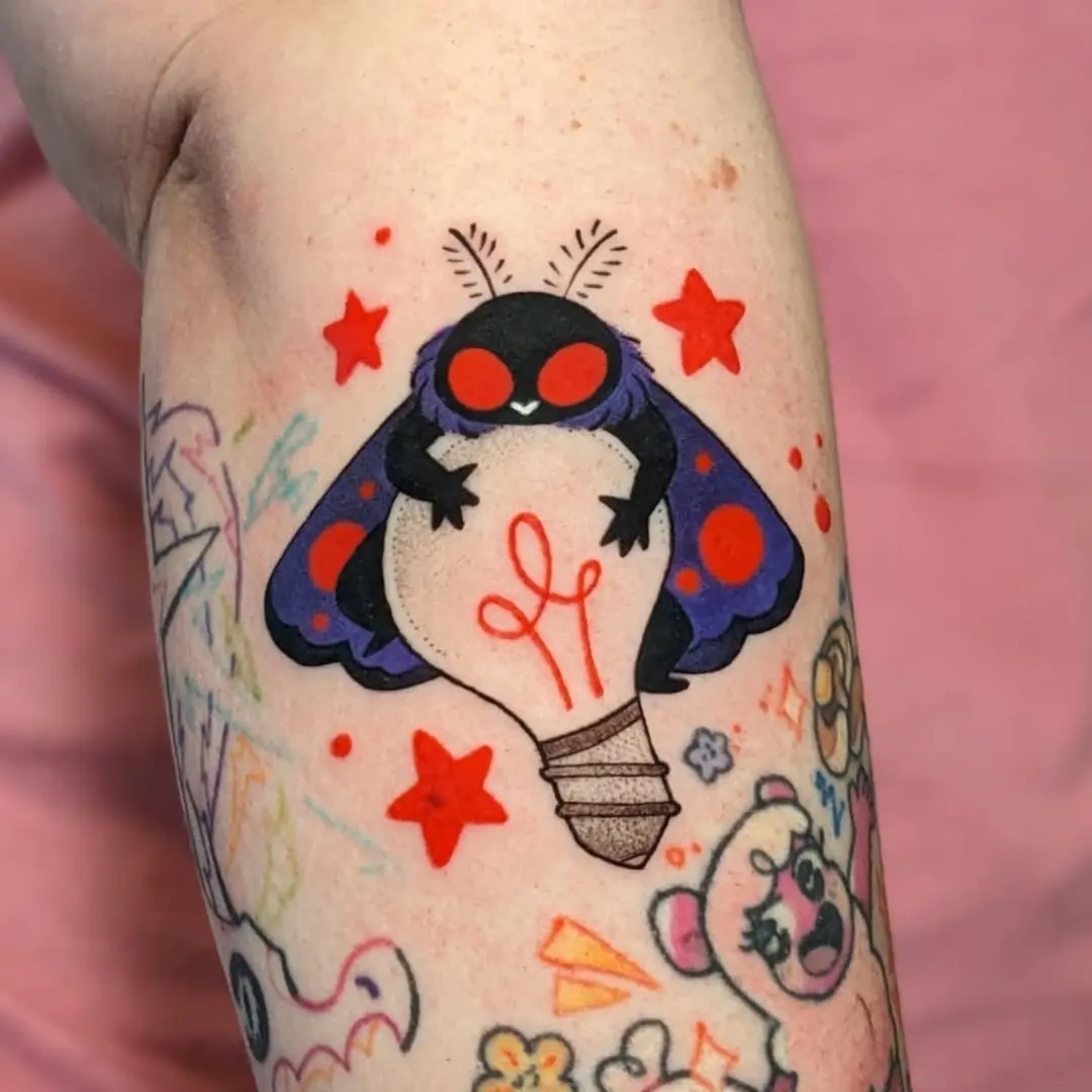 Whimsical moth tattoo with vibrant colors