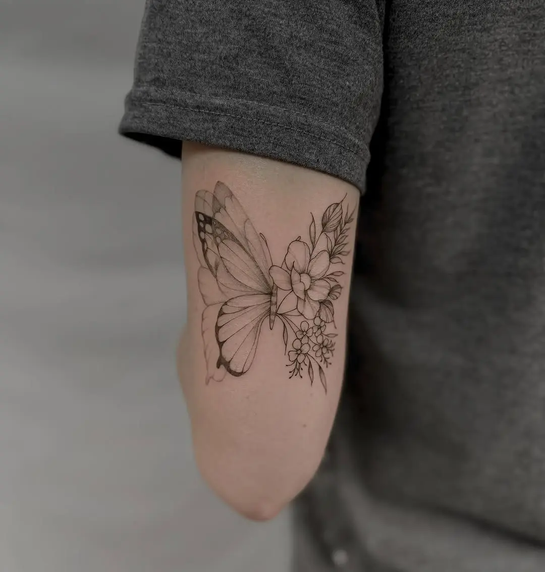 Aesthetic butterfly tattoo with floral elements