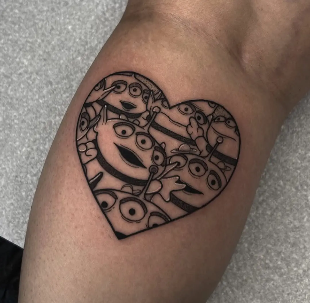 Charming heart-shaped tattoo featuring Disney aliens.