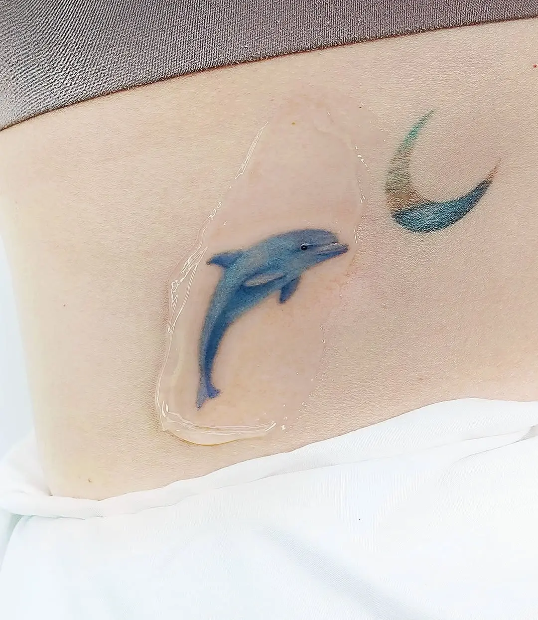 Colorful dolphin tattoo with crescent moon