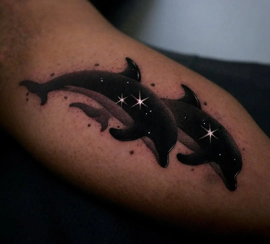 Stylish black dolphin tattoo with star accents