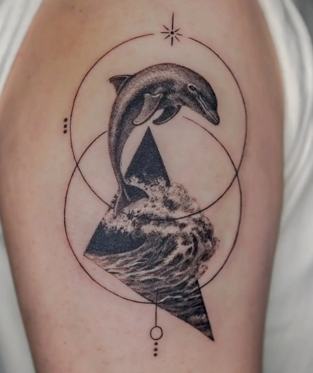 Stunning dolphin tattoo with geometric elements