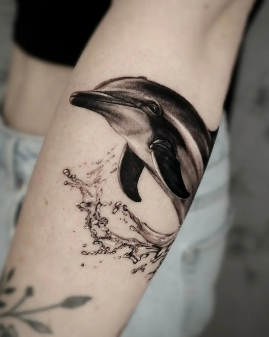Elegant realistic dolphin tattoo with water splash