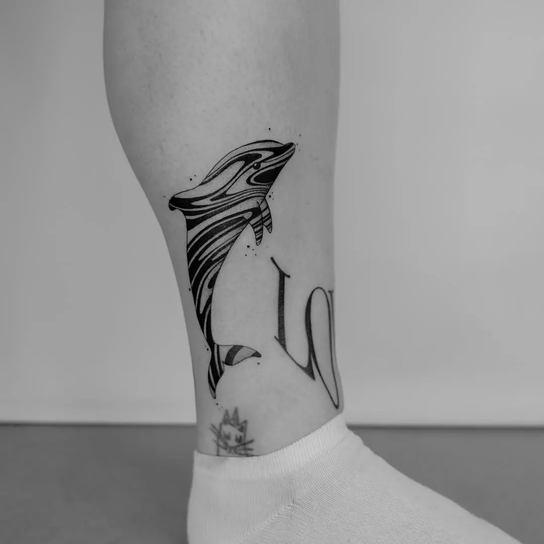 Stylized dolphin tattoo with elegant lettering