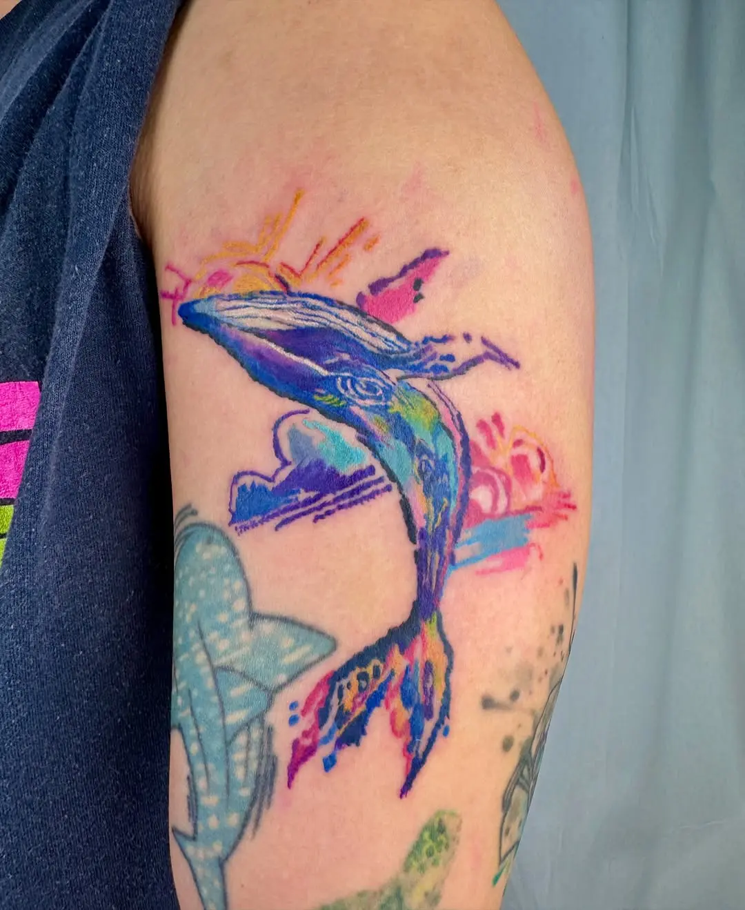 Colorful dolphin tattoo with a splash of life