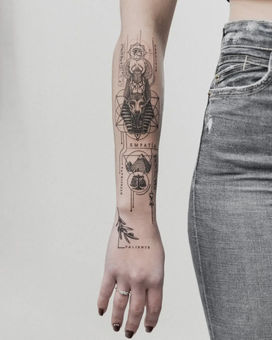 Intricate Egyptian-inspired tattoo on the forearm