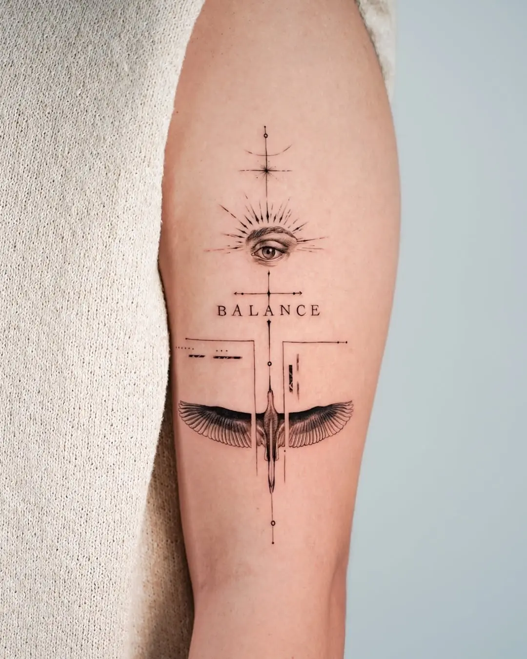 Symbolic tattoo combining balance and vision elements