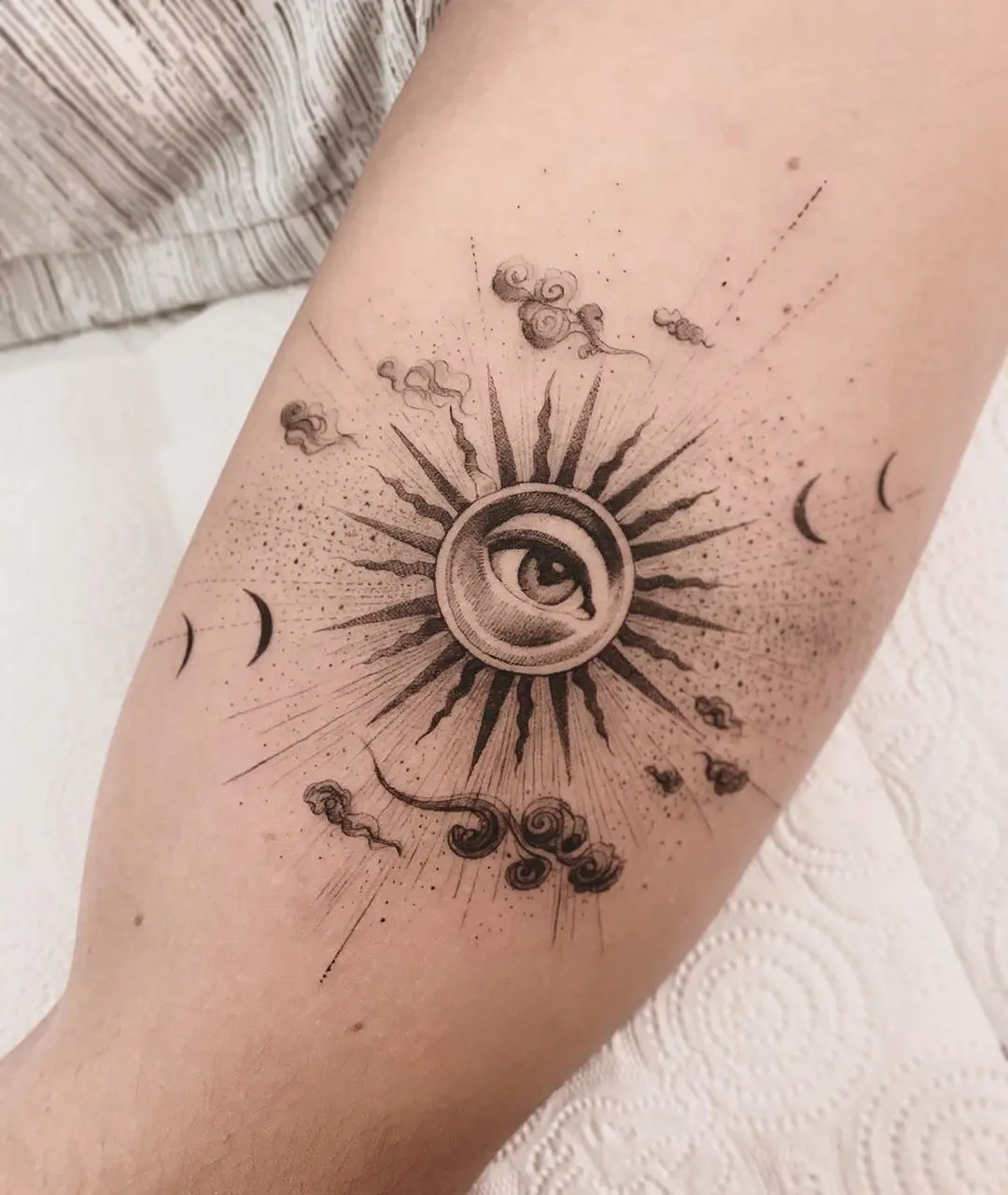 Symbolic Eye Tattoo with Celestial Elements