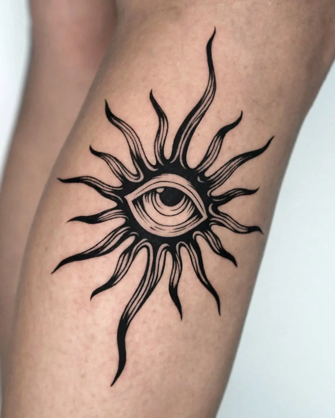 Stylish eye tattoo with sunburst elements