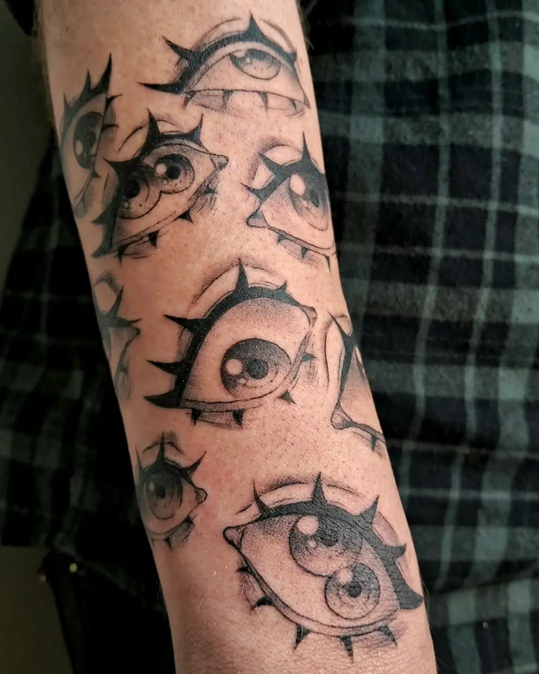 Intricate spiky eye tattoos on display
