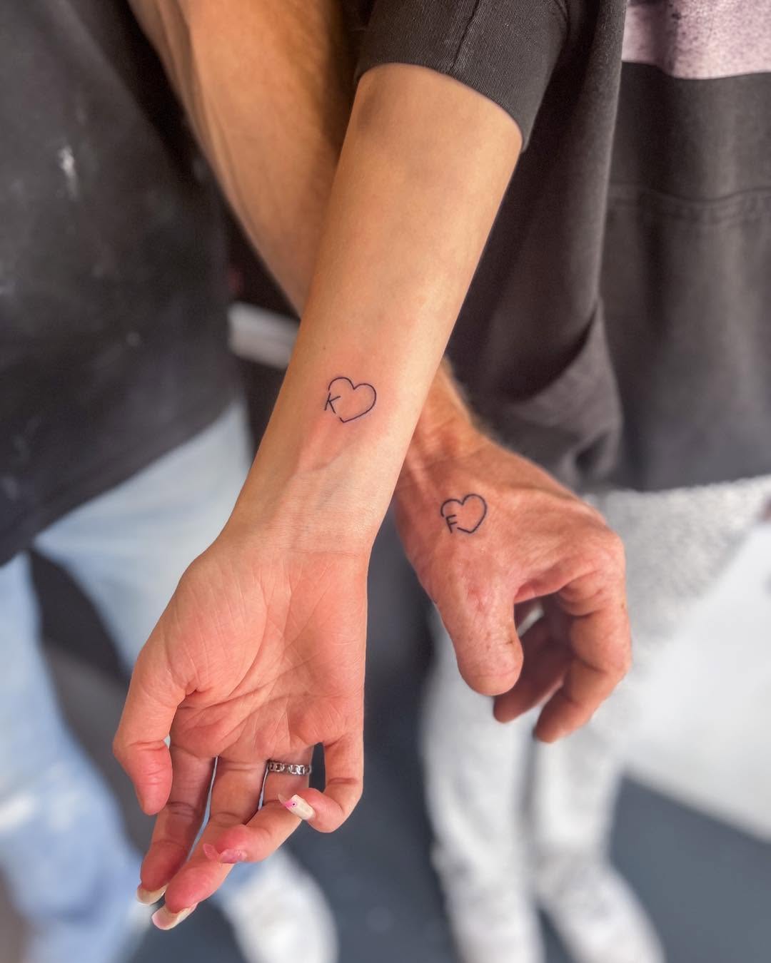 Minimalist heart tattoos symbolize father-daughter bond