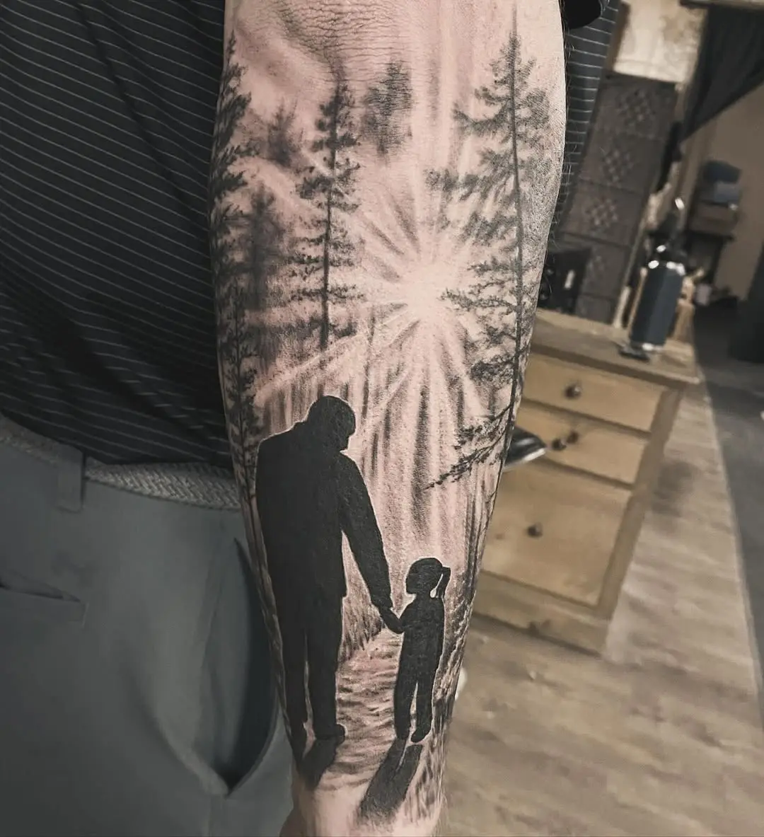 Heartwarming father-daughter silhouette tattoo design