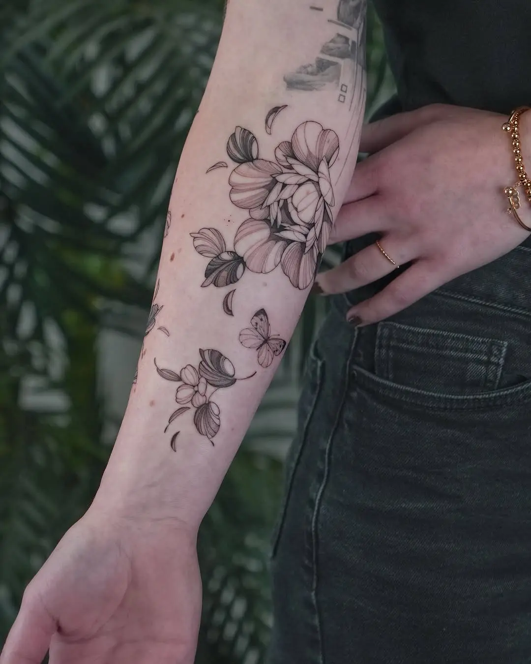 Elegant floral forearm tattoo with butterflies