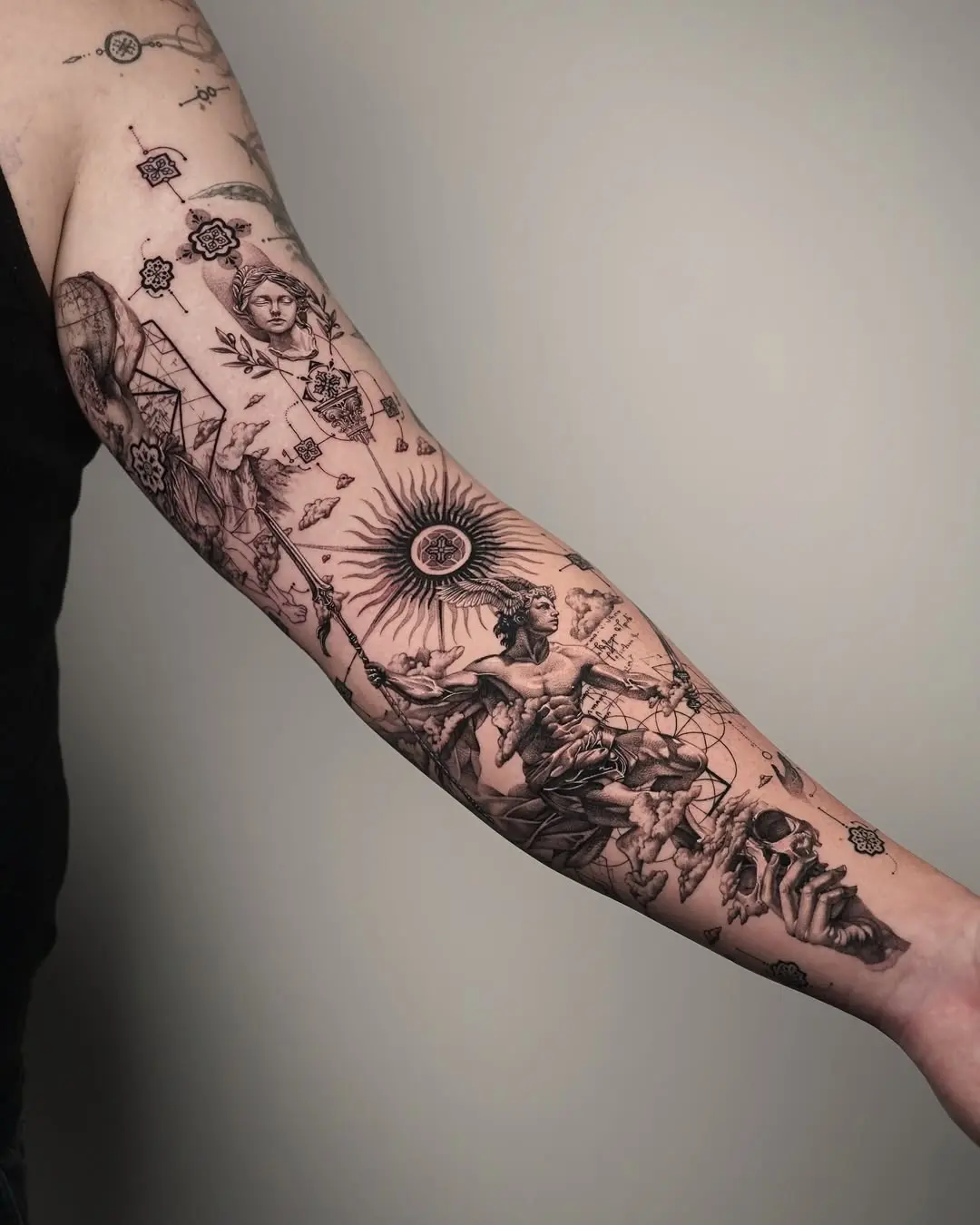 Intricate black ink forearm tattoo masterpiece