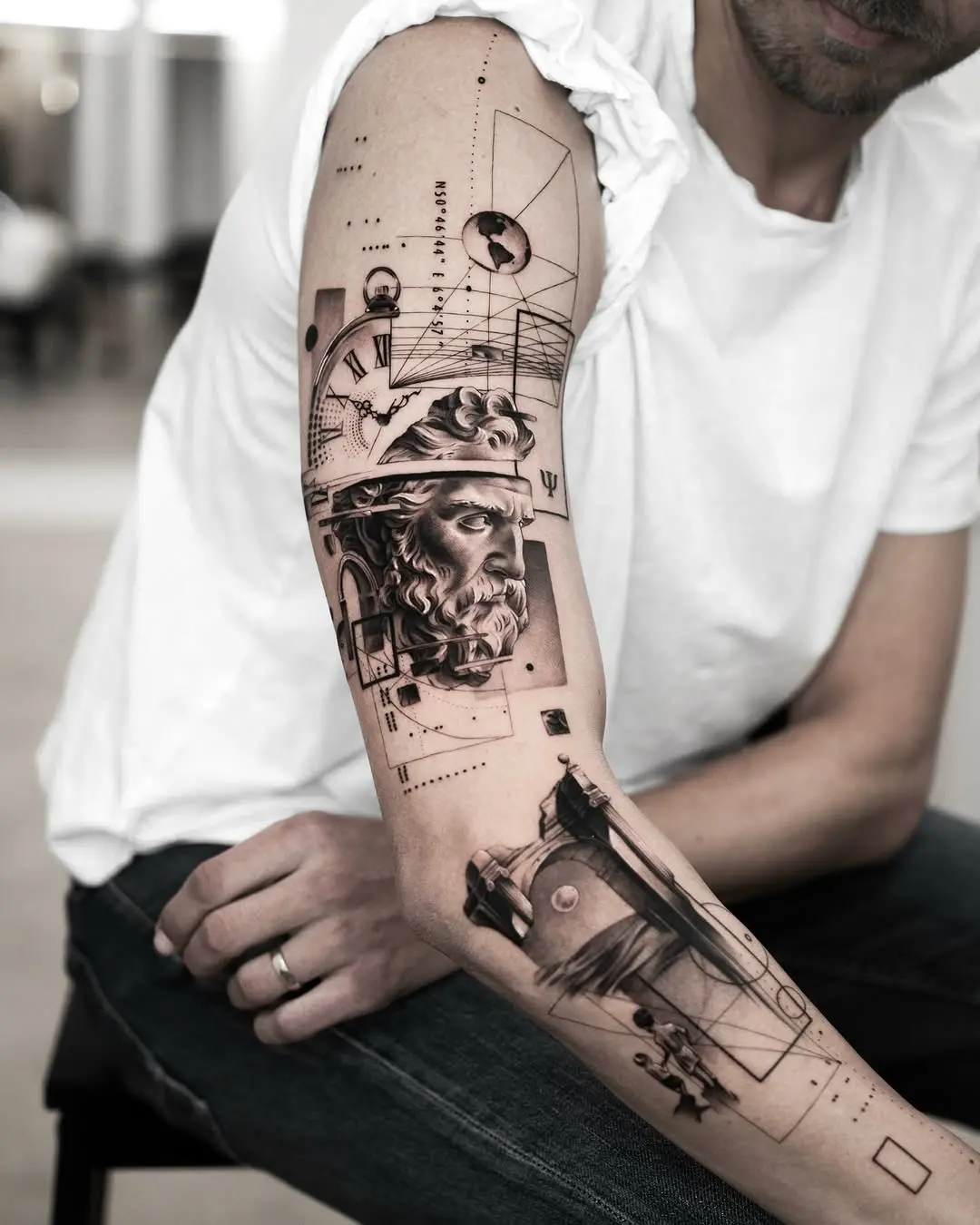 Intricate black and gray forearm tattoo design