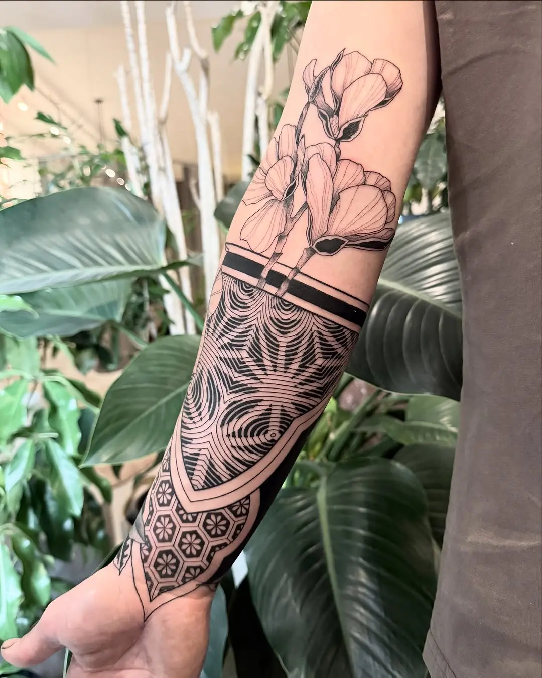 Stunning floral geometric forearm tattoo design