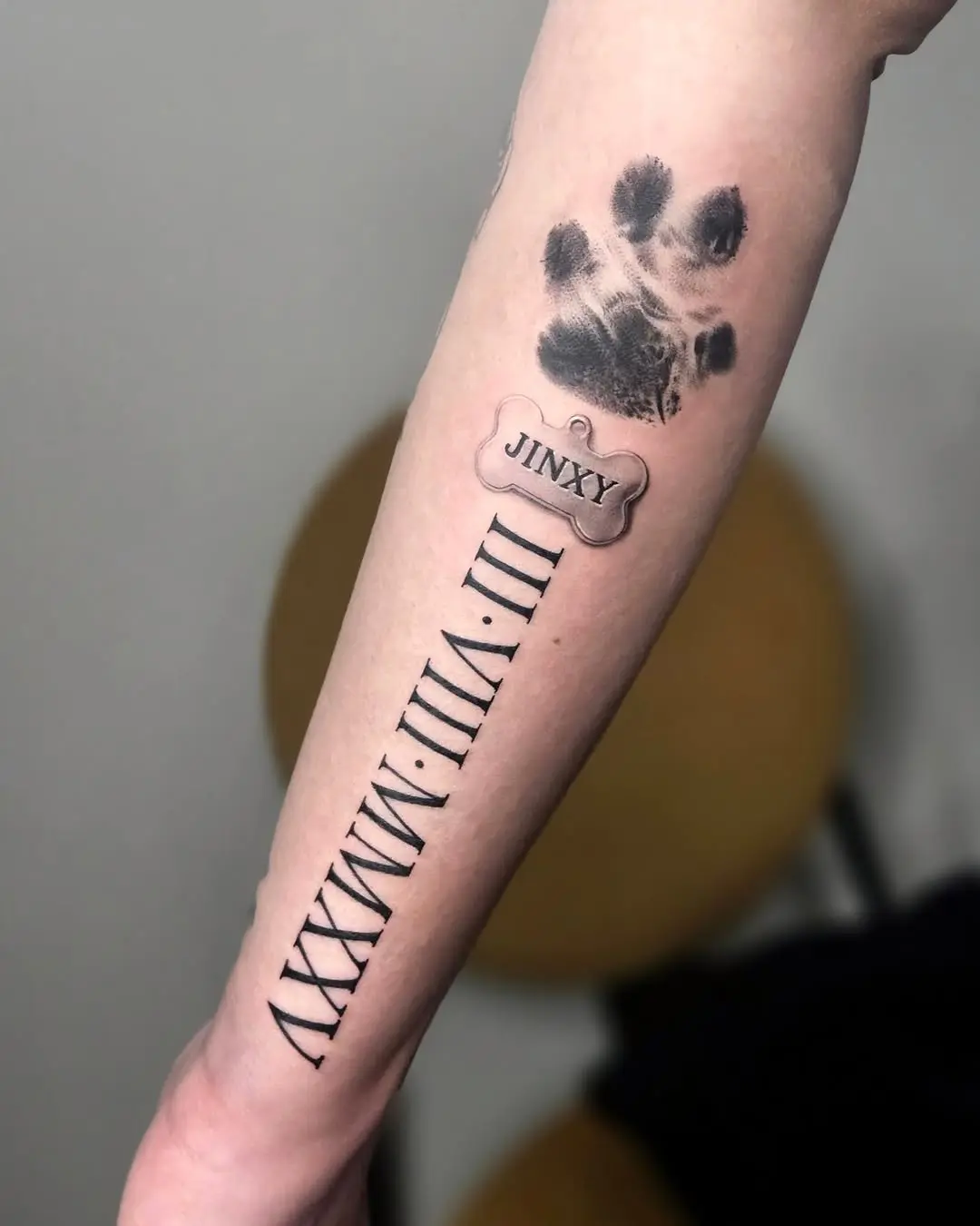 Personalized forearm tattoo with paw print