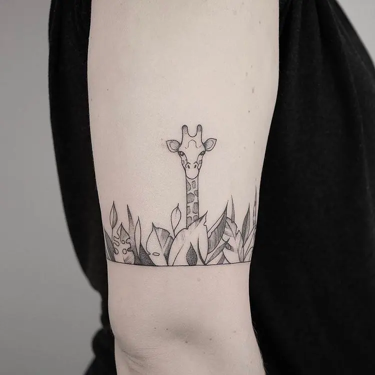 Charming giraffe tattoo peeking through foliage