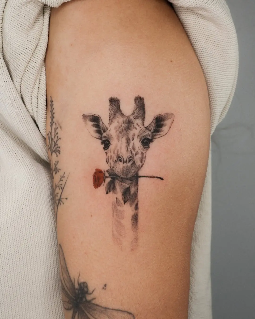 Charming giraffe tattoo with a playful touch