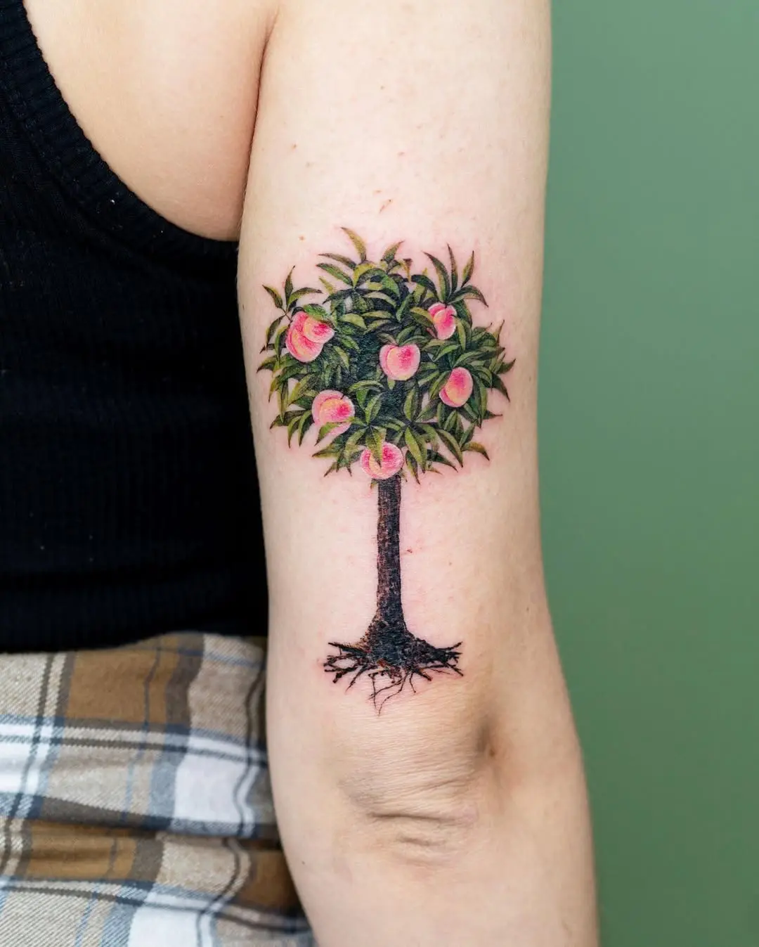 Vibrant tree tattoo with blooming pink flowers