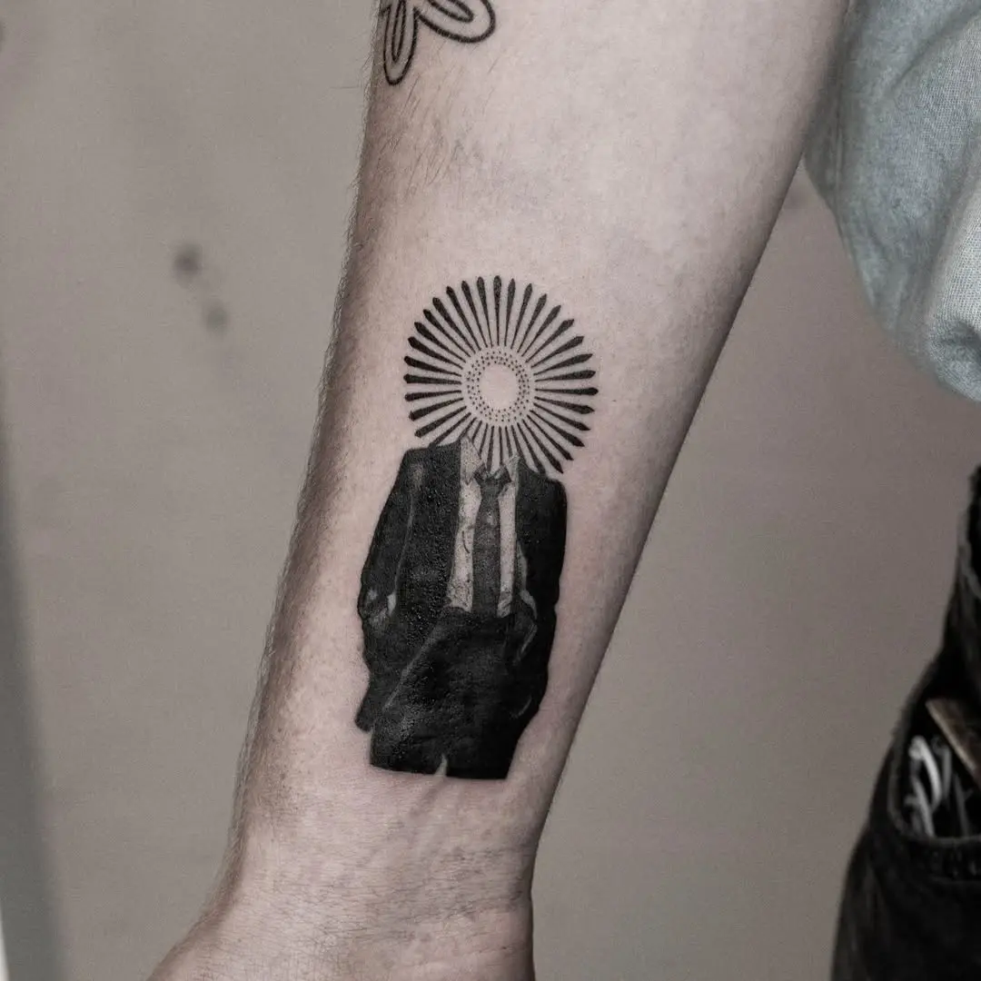 Unique tattoo blending suit and sunburst design