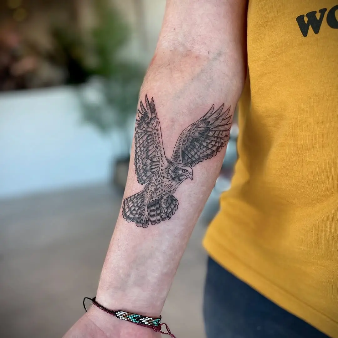 Majestic hawk tattoo soaring on forearm