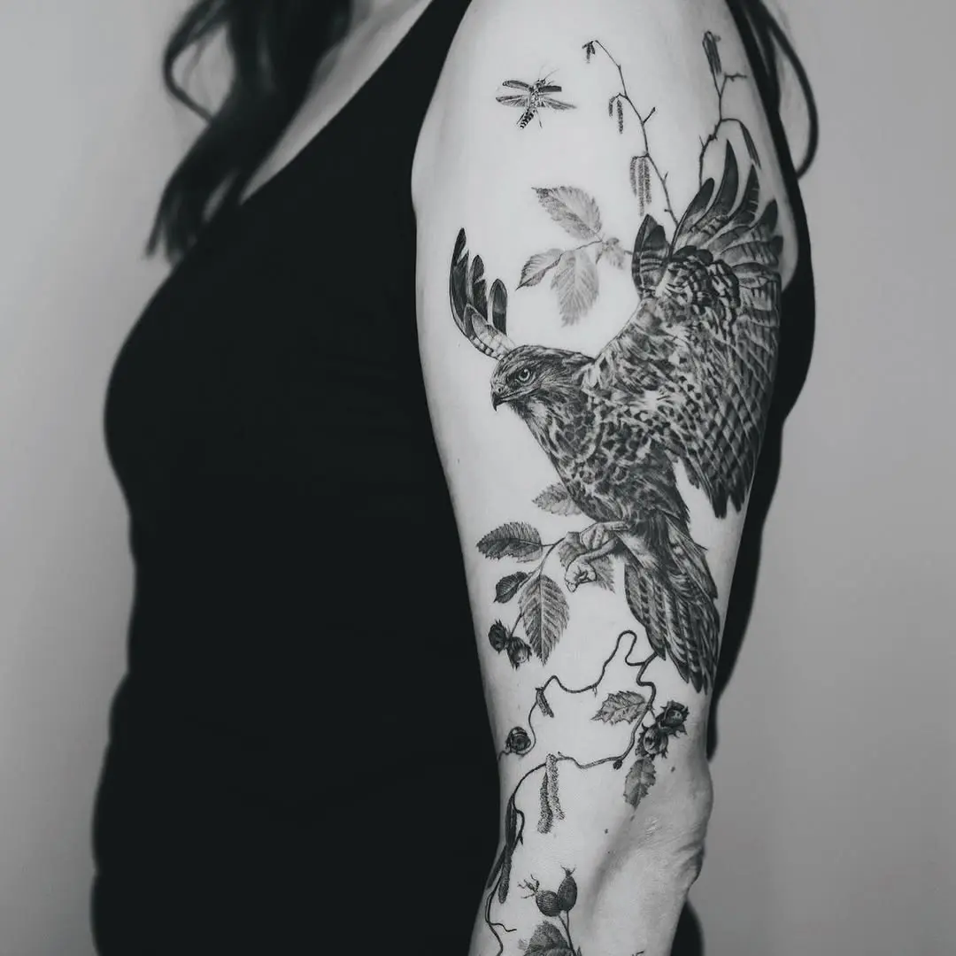 Elegant hawk tattoo with nature elements