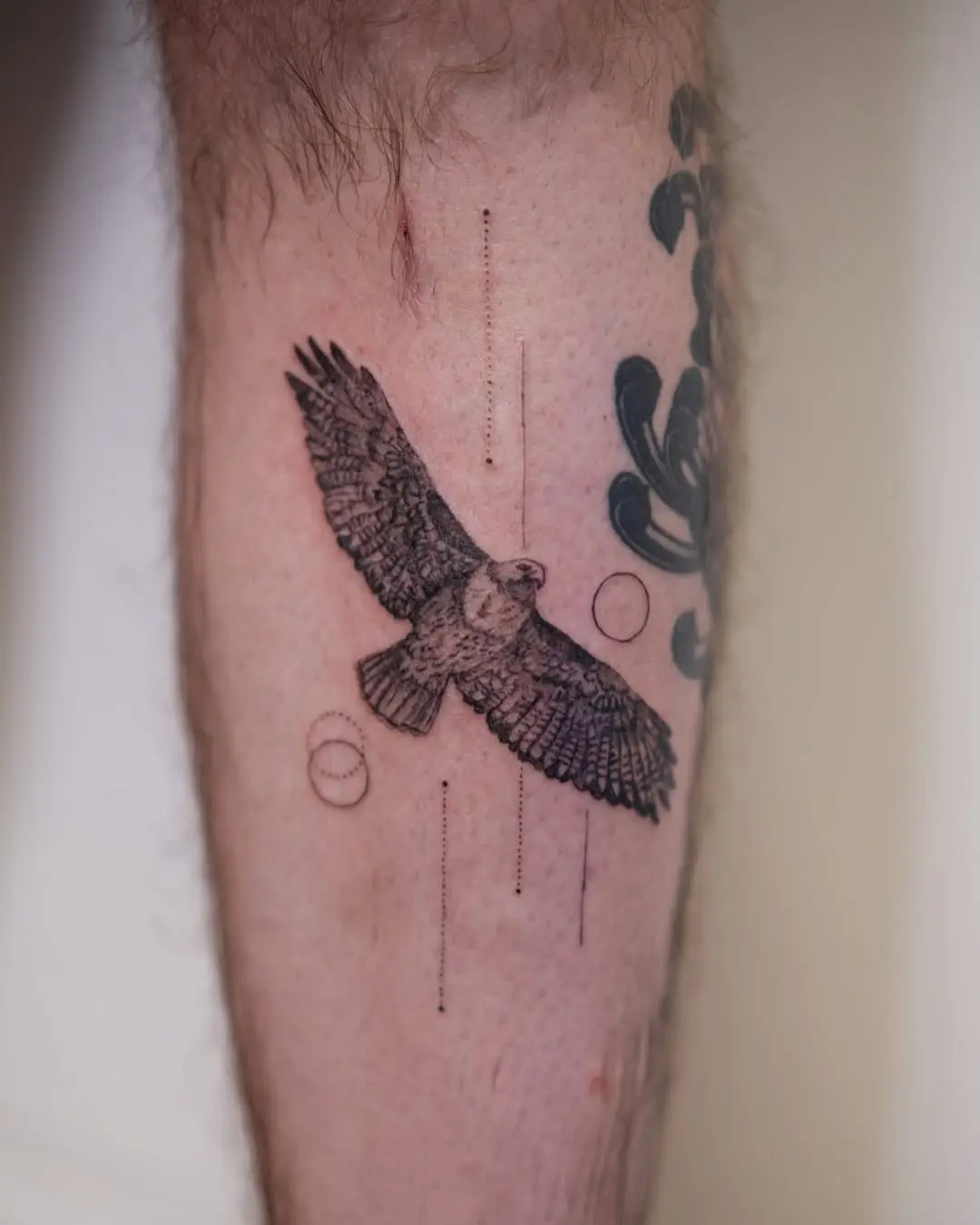 Intricate hawk tattoo in dynamic flight pose